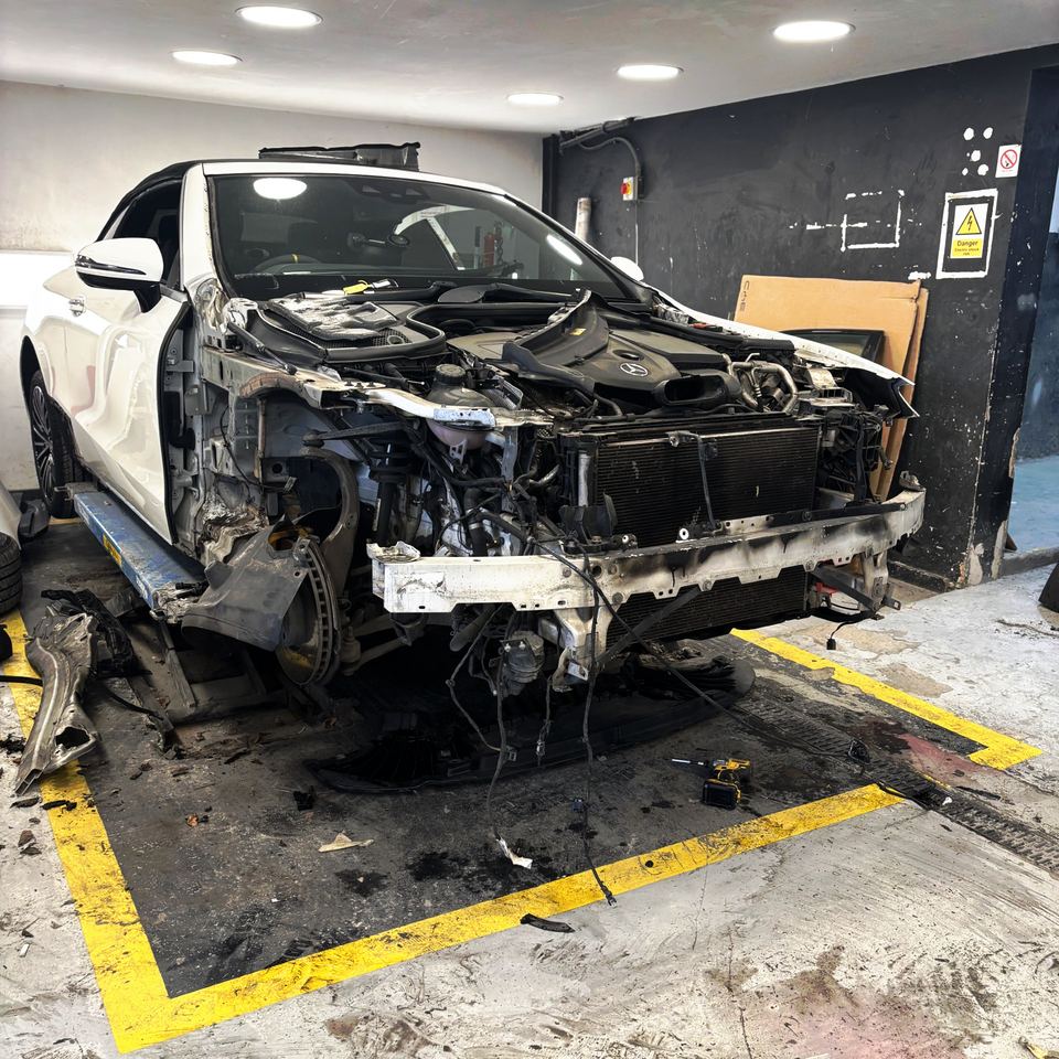 Mercedes-Benz C-Class Cabriolet with severe front-end collision damage, fluids leaking